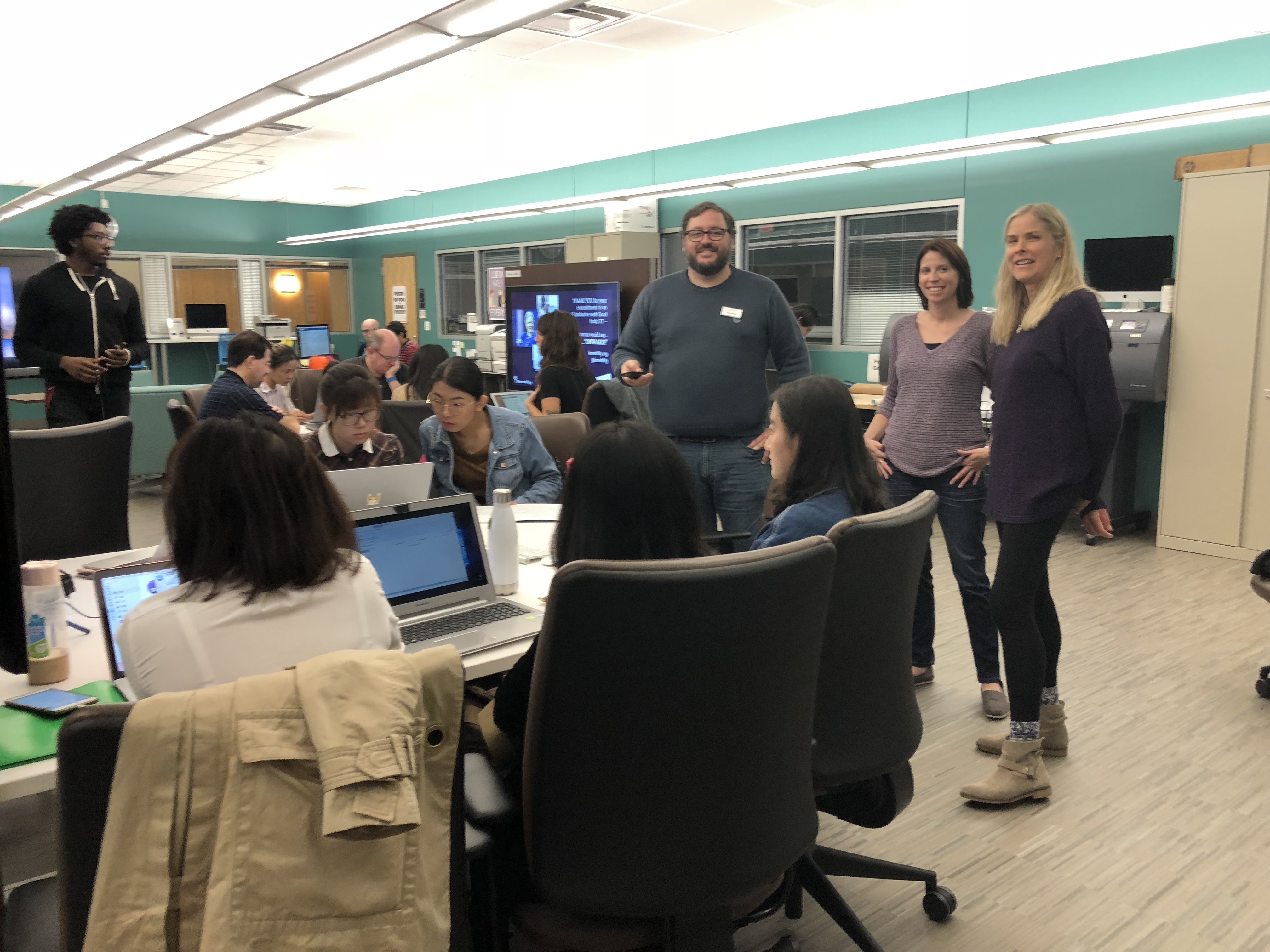 Student volunteer teams working in a computer lab.
